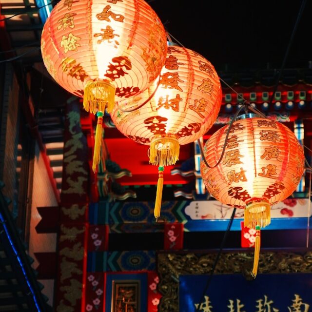 three orange hanging lanterns