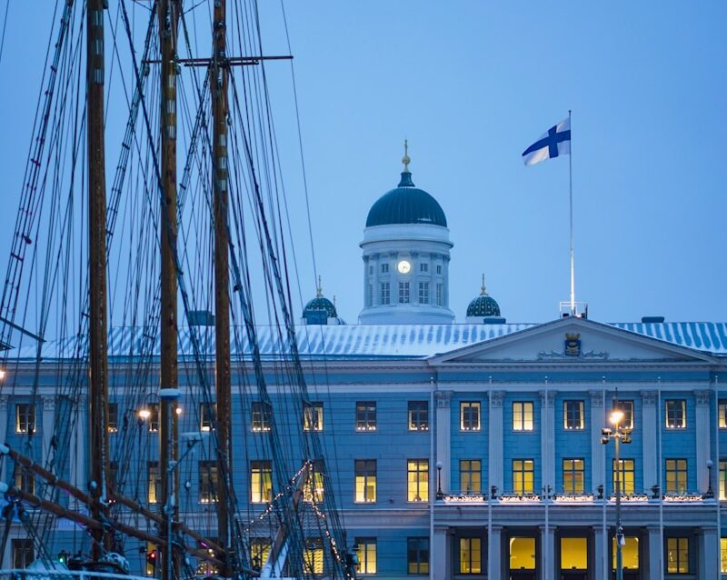 a boat is docked in front of a large building