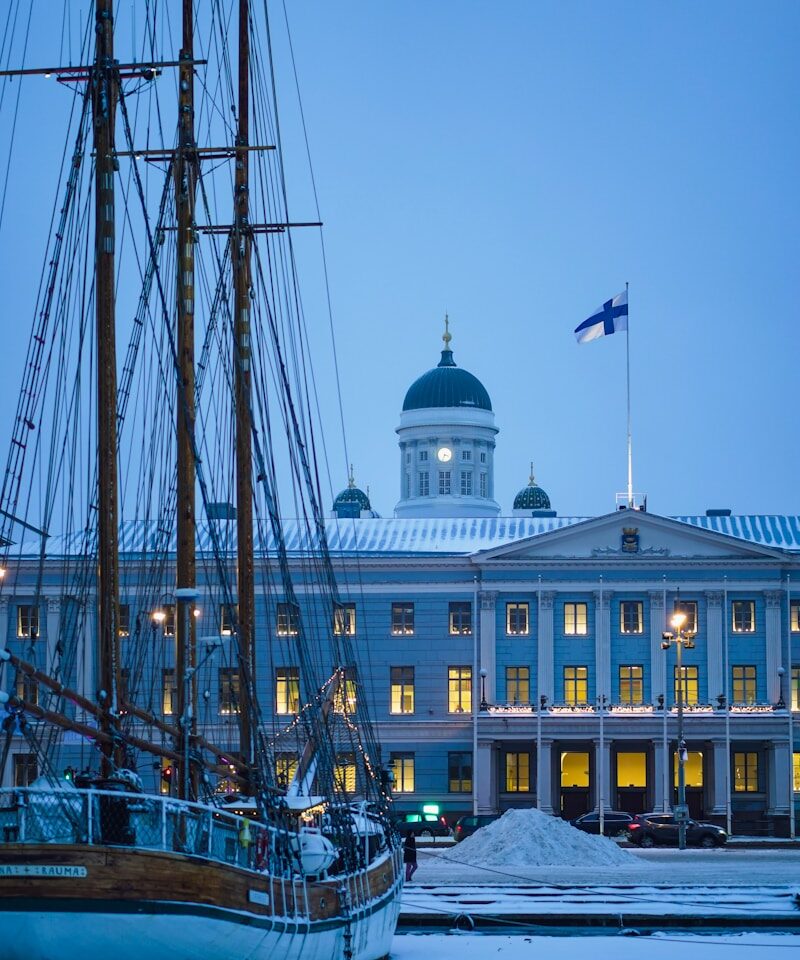 a boat is docked in front of a large building